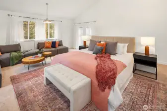 The upper level primary suite is a dream! The vaulted ceilings make the room feel quite expansive. Note the doors that lead to the Juliette balcony.