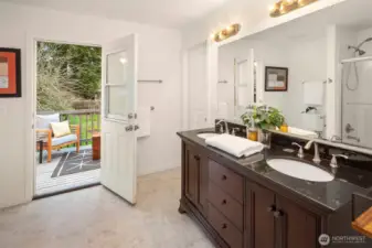 The upper primary en suite full bathroom boasts a sweet deck (newly refinished) that overlooks your backyard. The door on the right leads to the walk-in closet.