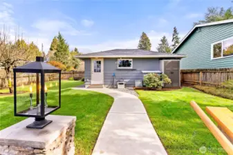 Double garage in backround. Electric car charger. Has it's own electric panel, sewer/water brought up to garage ready to plumb in, all underground. Second floor add on   garage  for ADU with swiping views. 5 extra parking spots. Perfesionally landscaped and utter perfection!