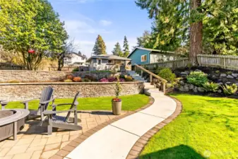 Double garage in backround. Electric car charger. Has it's own electric panel, sewer/water brought up to garage ready to plumb in, all underground. Second floor add on   garage  for ADU with swiping views. 5 extra parking spots. Perfesionally landscaped and utter perfection!