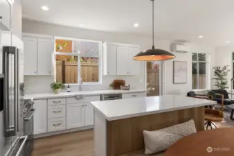 Quartz countertops, soft-close cabinet hardware and full appliance package in the kitchen.