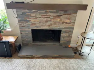 Updated wood fireplace with electric insert for ambiance