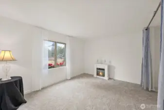 Main bedroom has large double-size closet, bright light from the window, and this cute electric fireplace can stay for a touch of cozy.