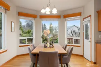 The dining room can accommodate at least 10-12 chairs easily.