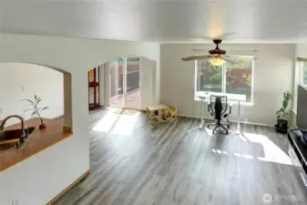 As you enter the home and look to the right, you'll see the living room in front, dining at far left and kitchen at near left.