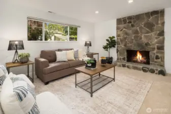 Lower living room w/wood fireplace