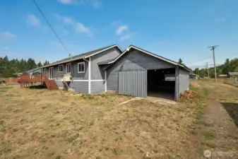 The garage comes with a sliding barn-style metal door that looks like it’s for one car, but at just over 23 feet long it can actually fit two in tandem. Access is from the alley, with a level yard that may be more “end of summer dormancy” than curb appeal. The siding on the garage could use some love, and that’s already been factored into the price.