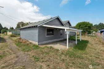 Behind the garage is where flexibility really shows up. The concrete pad and carport are ready for RV or boat storage, but could just as easily serve as a workshop zone or a backyard hangout. Think covered dining, a lounge setup, or the ultimate parking spot for your next restoration project.