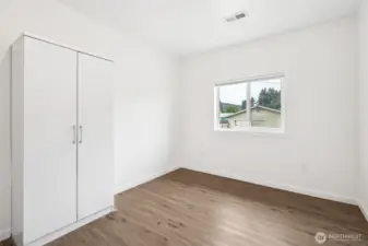 With a window for natural light, easy-care vinyl plank flooring, and clean white walls, this third bedroom is more of a blank canvas than a throwaway. Think 2nd home office, yoga room, craft zone, or just a cozy bedroom, it’s ready to become the space you’ve been missing.