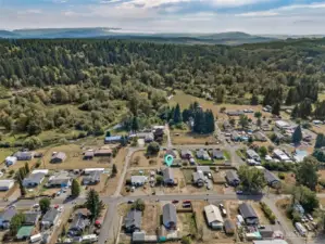 From above, you see Bucoda’s edge-of-town setting, surrounded by trees and just minutes from everything you need. Tenino is five minutes north with antique shops, Saturday farmers markets, and the Tenino Quarry Pool in summer. Grand Mound is ten minutes west with I-5 access, Great Wolf Lodge, brewery, and plenty of shopping and dining.