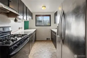 Kitchen with a window looking out to the side yard.