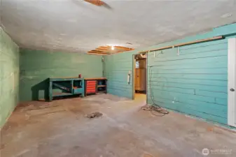 Attached 1-car garage with a workshop area in the corner.