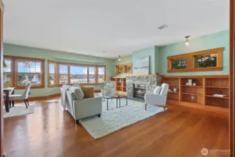 The reclaimed wood floors goes so well with the built-ins and trim. The gas fireplace keeps you cozy too.