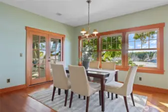 Light filled dining room with double doors (with hidden screens) out to the deck overlooking Swantown Marina.