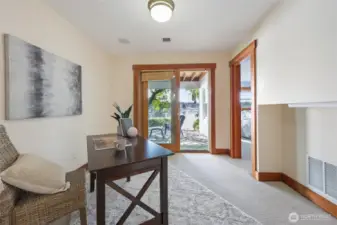 Den just off the primary bedroom and hall leading to the back patio and waterfront.