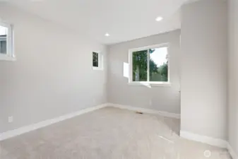 Downstairs Primary Suite features picture windows, two closets, and primary bathroom.