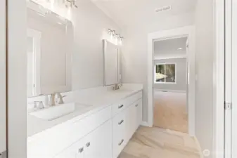 This Jack and Jill bathroom is share between bedrooms #3 and #4, long double sink vanity, with pocket doors on each bedroom for privacy, titled flooring, under cabinet lighting, and a separate toilet and shower room!