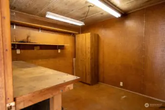 Shed off of carport with electrical complete with lights and work bench