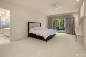 Primary bedroom with views of the golf course & patio