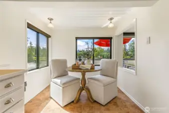This charming breakfast nook affords a lovely view of the water and gardens.