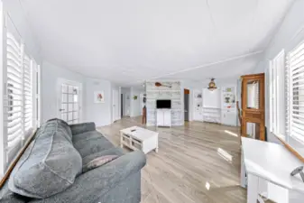 Living room showing dining area and hallway to bedrooms