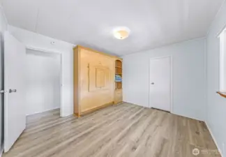 2nd bedroom with custom built queen sign murphy bed that also has a table