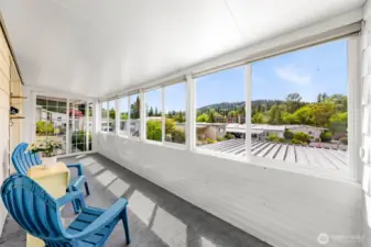 Sunroom facing SW with UV rolling shades and sliding glass door