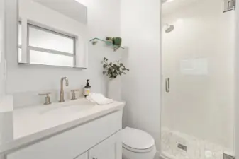 Primary bath taken to the studs and fully remodeled in 2019 with contemporary tile, glass-enclosed shower, and updated fixtures. A clean, modern design delivers both daily comfort and long-term value.