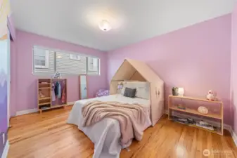 Bedroom Two offers generous proportions, hardwood floors, and a wide window that brings in natural light. A versatile layout accommodates bedroom, guest suite, or office use while maintaining the home’s clean, modern aesthetic