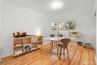 Bedroom Three offers expansive flexibility with hardwood floors, corner windows, and abundant natural light. Ideal for a home office, guest room, or creative studio, this space adapts effortlessly to evolving lifestyle needs
