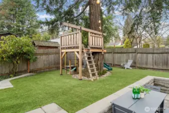 A custom-built treehouse adds a rare lifestyle element, transforming the yard into a private retreat under soaring trees. Gated alley access enhances versatility with additional parking, including space for a small RV.