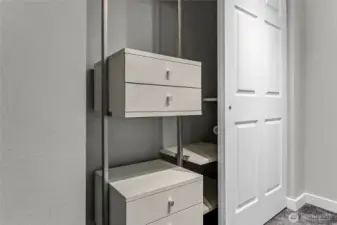 Custom closet system in primary bedroom  maximizes storage.