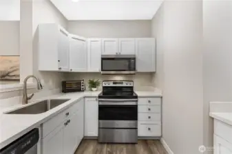 Stainless steel appliances and abundant cabinetry offer both style and functionality.