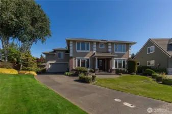 Welcoming walkway leads to a column-accented front entry.