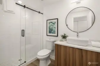 Hall bathroom with custom cabinets, quartz countertops and shower