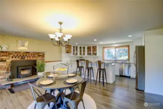 Enter into the kitchen eating nook off the covered patio. A perfect place to gather and be cozy around the wood burning fireplace insert on cold winter days.