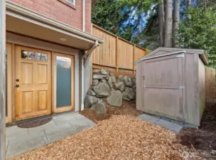 The lower level has its separate entrance and small outdoor area with a shed for storage. Sidelight windows and lights on the door draw light within the family room ground floor. ADU possible?