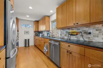 Open kitchen for the cook to be among family and guests. Shaker style solid cherry cabinetry, honed granite countertops, tumbled-faced marble subway backsplash.