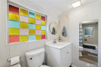 Primary full bath has touches of the original 1910 home.