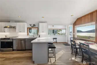 Kitchen has sit-down bar and separate dining area.