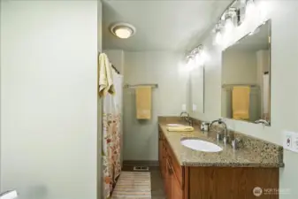 Primary Suite has Quartz Counters, Skylight, Walk-in Shower
