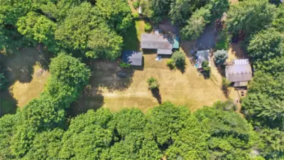 2.3 private acres with so much potential! Build your dream home (including ADU?) while storing equipment in the shed and renting out the manufactured homes!