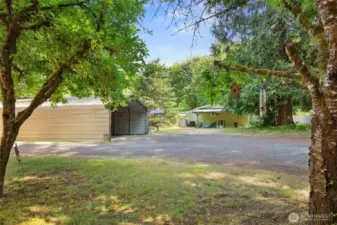 Entering the property you can see the large, detached carport here.  6325 is seen ahead with attached carport.