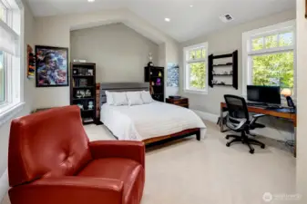 One of 4 upstairs bedrooms, all with soaring vaulted ceilings, with this one in particular having an en suite bathroom.