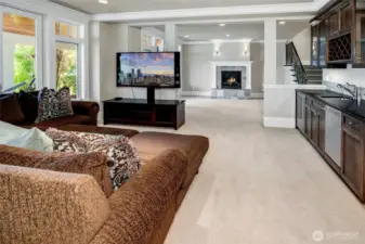 On the other side of the rec room sits an extensive wet bar, and additional seating or gaming area.