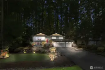 Landscaped lights makes this home stand out at night.