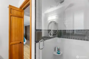 Full tile shower with wide swinging glass door