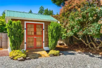 Darling and functional storage shed, also with a metal roof