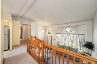 Hallway to guest bath, primary with ensuite and two additional bedrooms