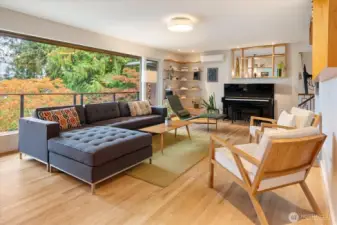 Another angle of the living room showcases the large picture window with Lake Washington and treetop views.